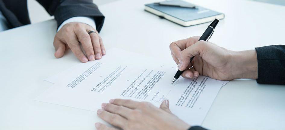 Image of a contract being signed