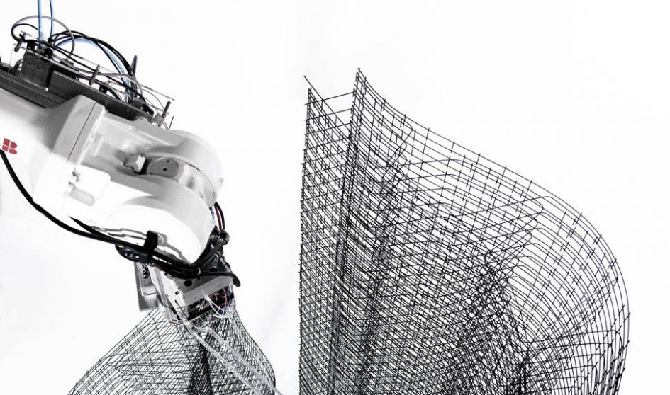 Robot builds steel cable grids for various concrete moulds.