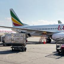 Addis Ababa, Ethiopia - April 23, 2019: Ethiopian airlines Boeing 737 waiting at ground on sunny day, another A350 aircraft behind. EAL are largest Africa airline